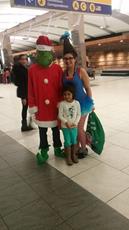 Grinch with his Who and a little one in front of  Arrivals